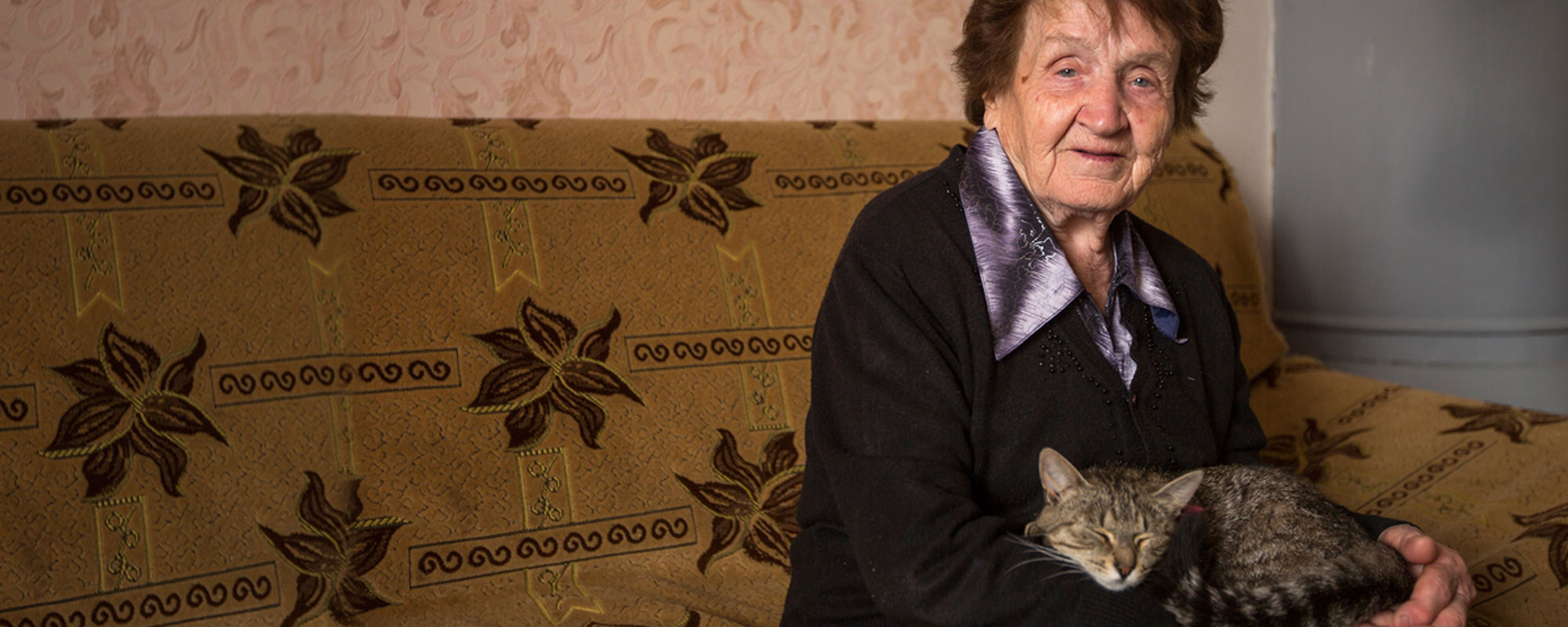 An older client at home with her cat